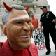 A protester with a mask of President Bush demonstrates outside the Cannon House Office building in Washington as U.S. Army General David Petraeus and U.S. Ambassador to Iraq Crocker testify inside in Washington